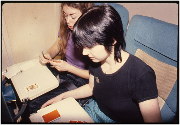 Annastacia McDonald and Jeanette Reinhardt playing cards during a flight, tour de '4', 1980, Courtesy of Paul Wong