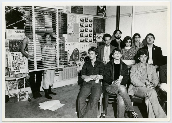 Standing: Hank Bull, Kate Craig. Audience seated from back to front: Sid Morozoff, unidentified, Warren Knetchel, Rosemary Brown, Danny Kostyshin, unidentified, Roy Arden, Dave Enblom, High Profile Slow Scan performance, Video Inn, October 13, 1978, Courtesy of Paul Wong